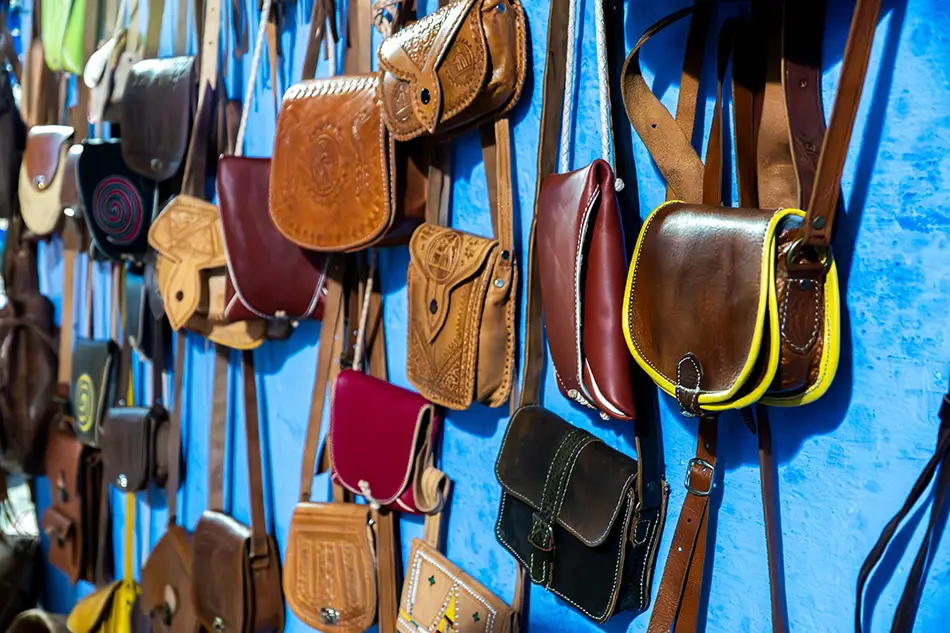 Leather bags on the walls showing shopping as a best thing to do in chefchaouen