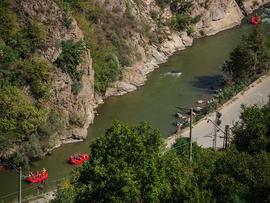 Rafts float down the Debed River, capturing Best Things to Do in Alaverdi.