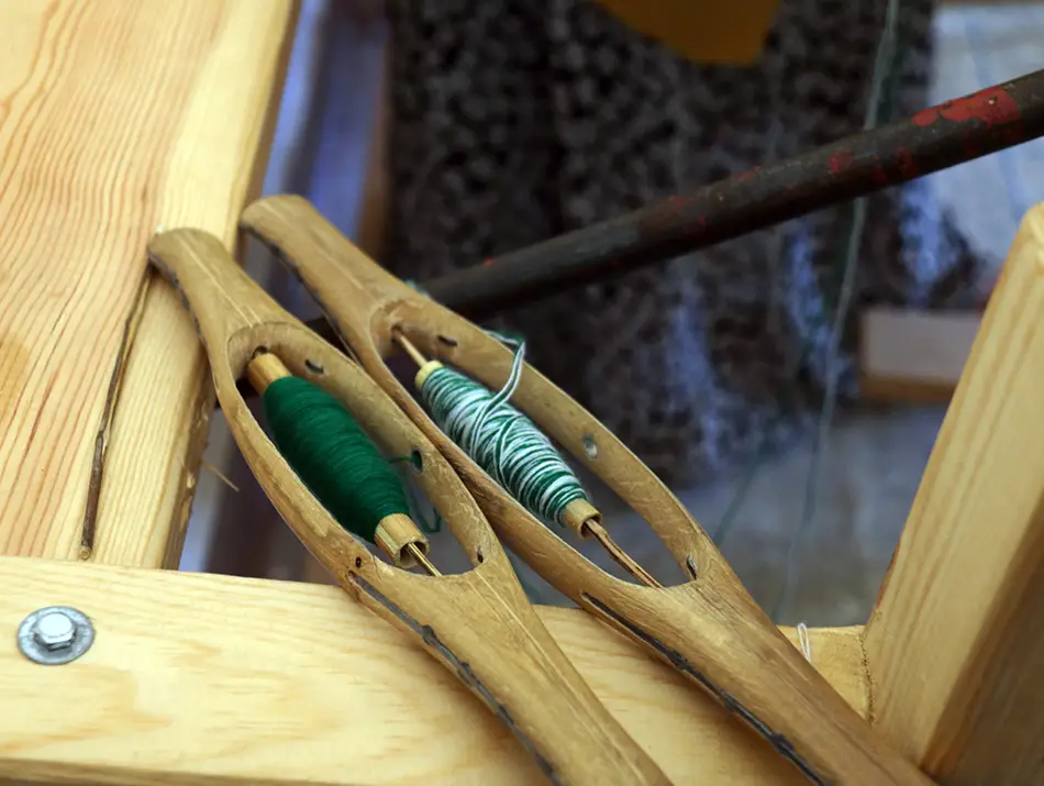 Artisan weaving cooperative with handmade textiles in vibrant patterns.