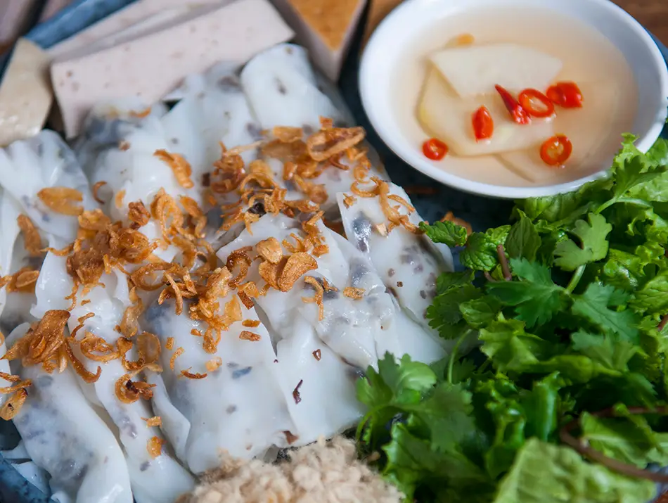 Steamed rice rolls filled with pork and mushrooms — famous Vietnamese foods from the north.
