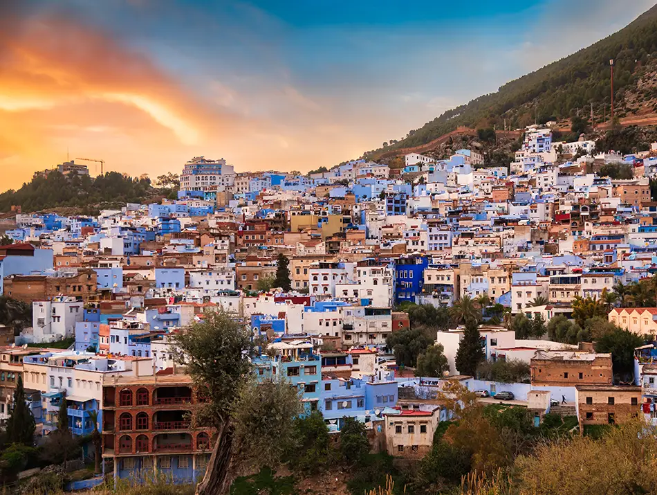 Aerial view of the hillside town showing Chefchaouen at a glance with clustered houses.