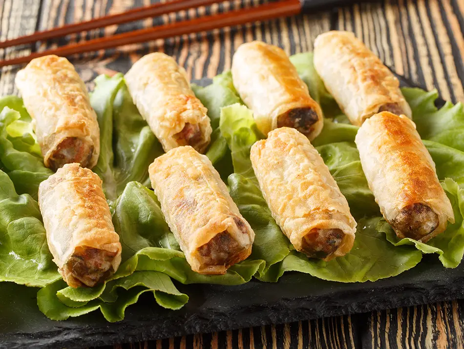 Golden fried spring rolls with pork and shrimp, known as nem rán or chả giò.