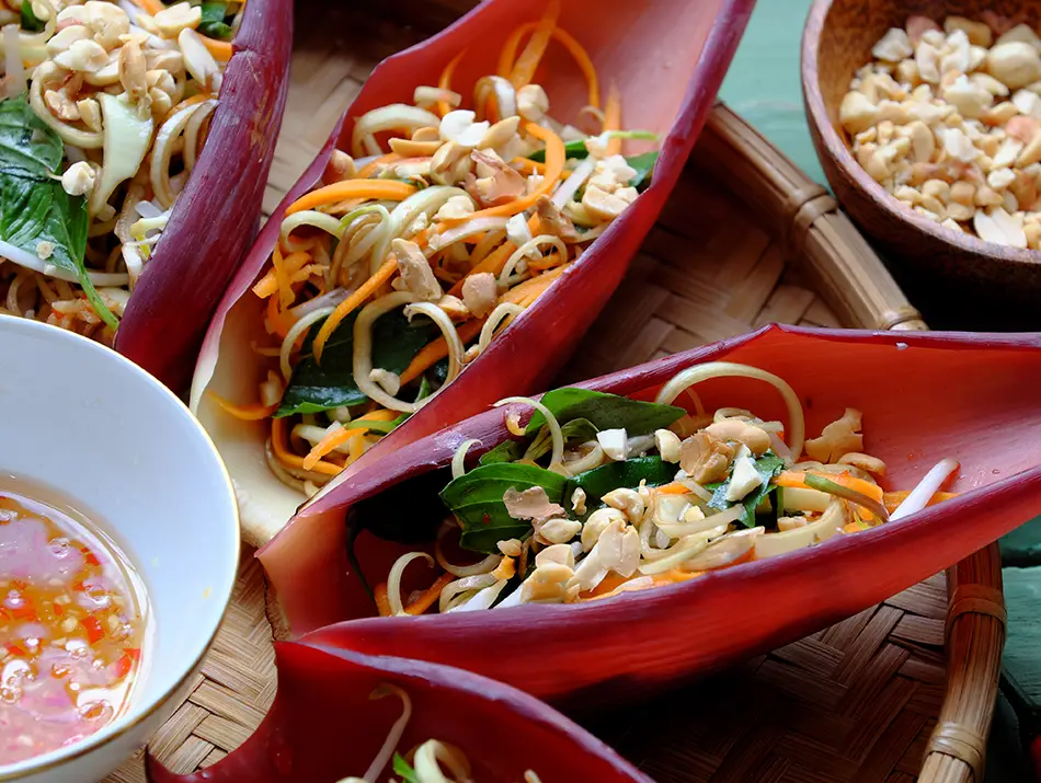 Banana blossom salad with shredded chicken, carrots and roasted peanuts — traditional Vietnamese dishes.