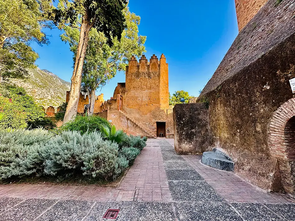 Historic kasbah fortress, one of the top attractions in Chefchaouen, with palm trees nearby.