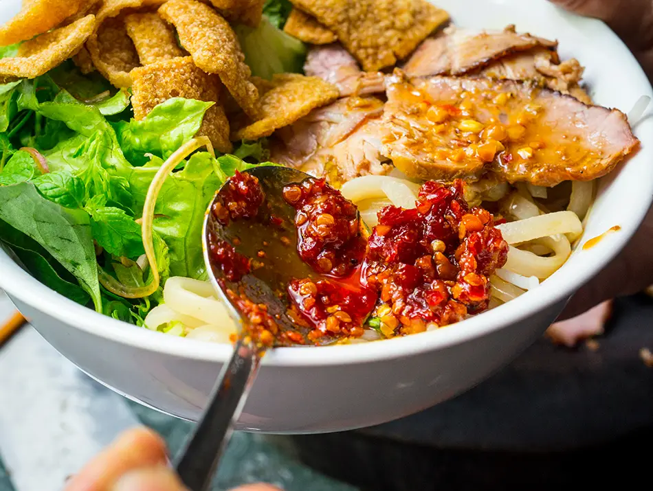 Cao lầu noodles with roast pork, greens and croutons in Hội An, among the best dishes in Vietnam.