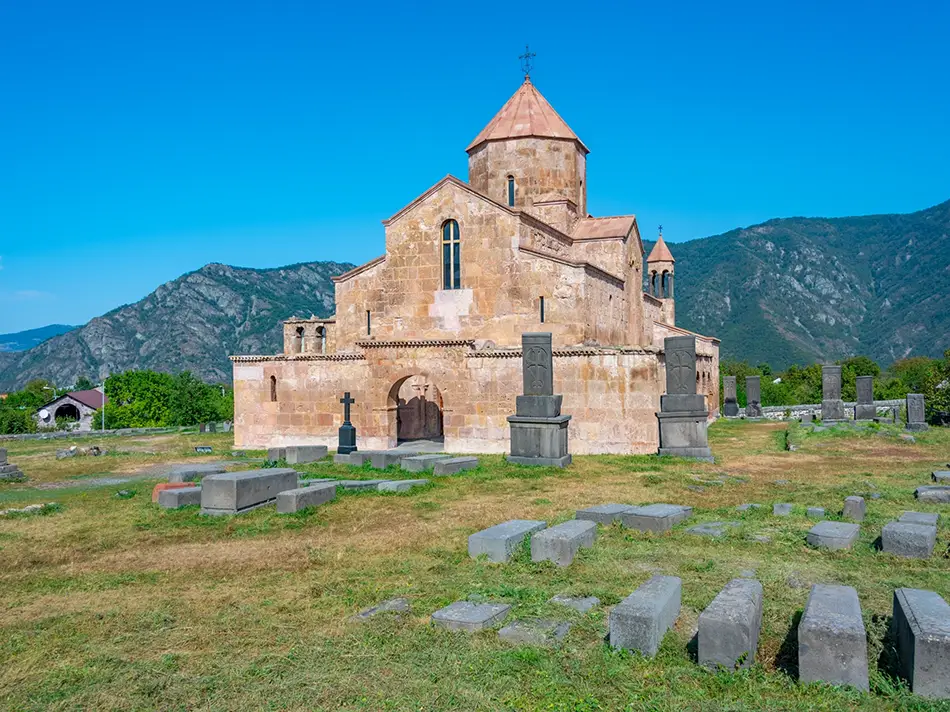 Odzun Church crowns a grassy plateau above Alaverdi in Armenia with khachkars.