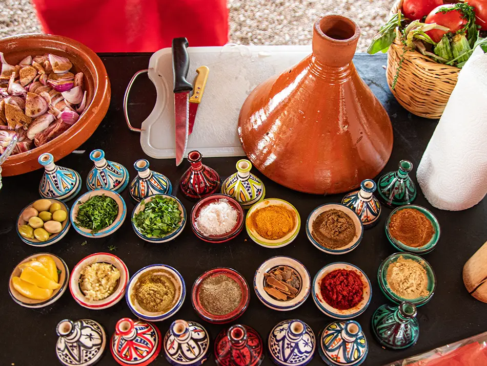 Colorful spices and herbs arranged for a Morocco cooking class in Chefchaouen.