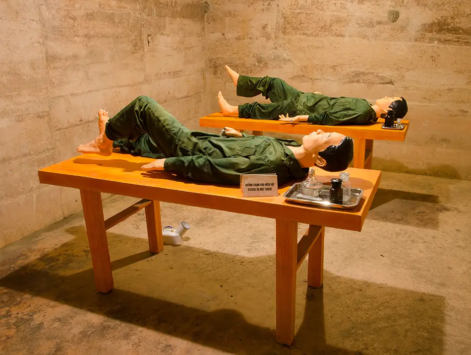 Two mannequins on hospital beds inside Hospital Cave, one of the top attractions in Cat Ba Vietnam.