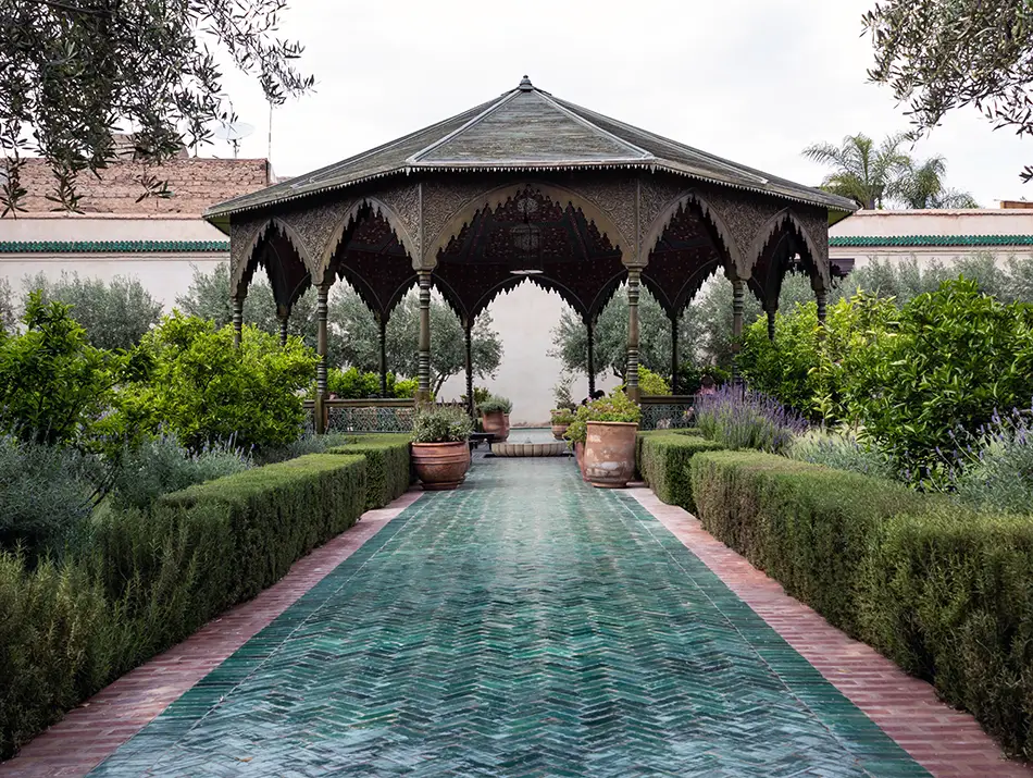 Islamic-style pavilion in the Secret Garden of Marrakesh surrounded by greenery