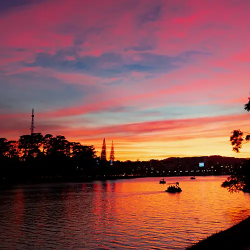 Vibrant pink and orange sunset over Xuan Huong Lake, one of the best sunset spots in Dalat.