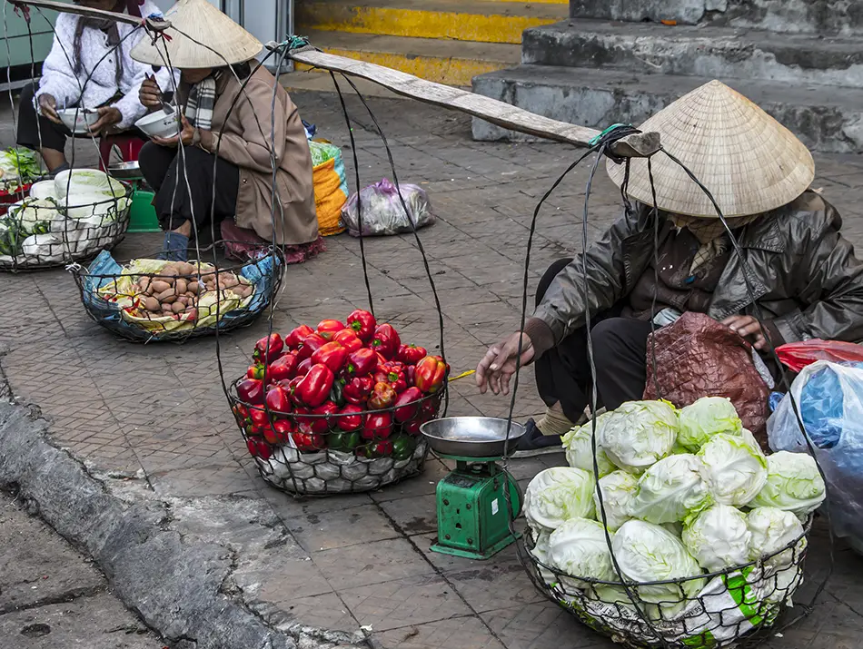 Street vendors selling fresh produce at the morning market, capturing everyday local life.