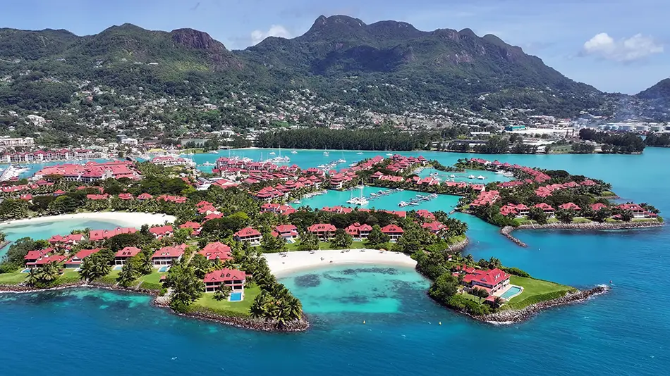 Overwater villas on Mahe Island ideal dream travel destination by clear lagoon.