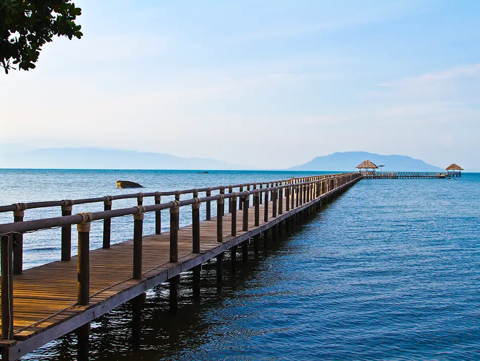 Pier stretching into the blue ocean in Kep - among the best places to visit in Cambodia.