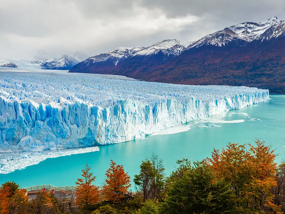 Vast blue glacier wall meeting lake waters in one of the best countries to visit.