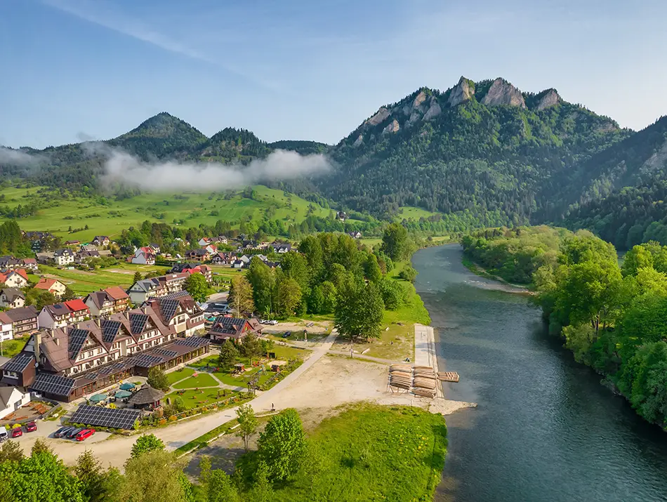 Mist lifting over peaks and river valley.