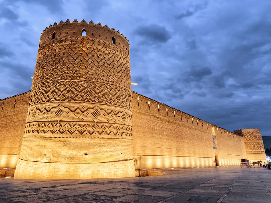 Illuminated brick citadel walls at dusk in one of the best countries to visit.