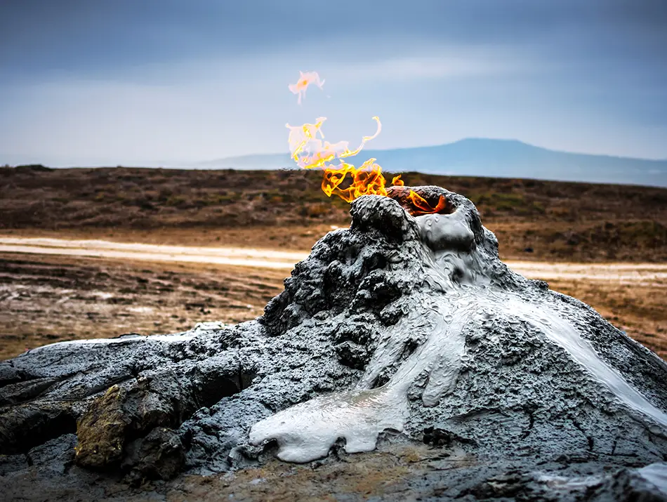 Bubbling mud volcano landscape under open sky in a best adventure country setting.
