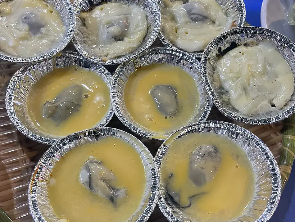 Grilled oysters served as popular street food in Nha Trang, Vietnam.