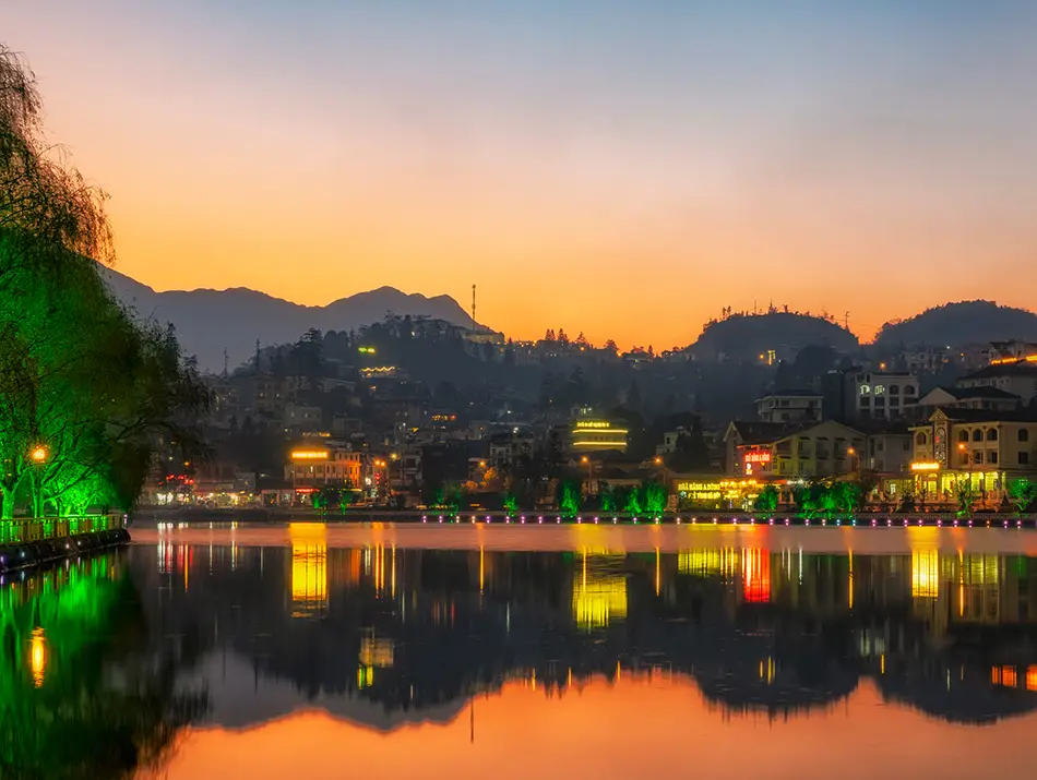 Evening lights shimmer across Sapa’s main lake, offering a peaceful reminder of why people enjoy visiting Sapa.