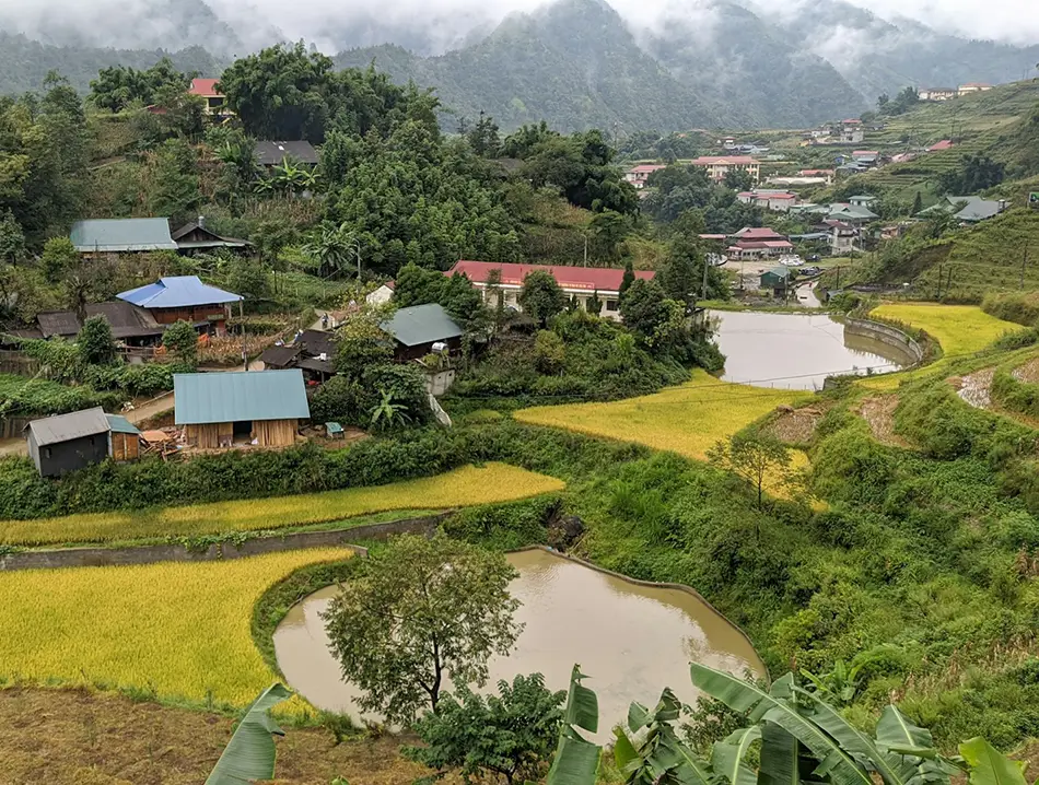 Colorful hillside homes and rice terraces surround Cat Cat Village