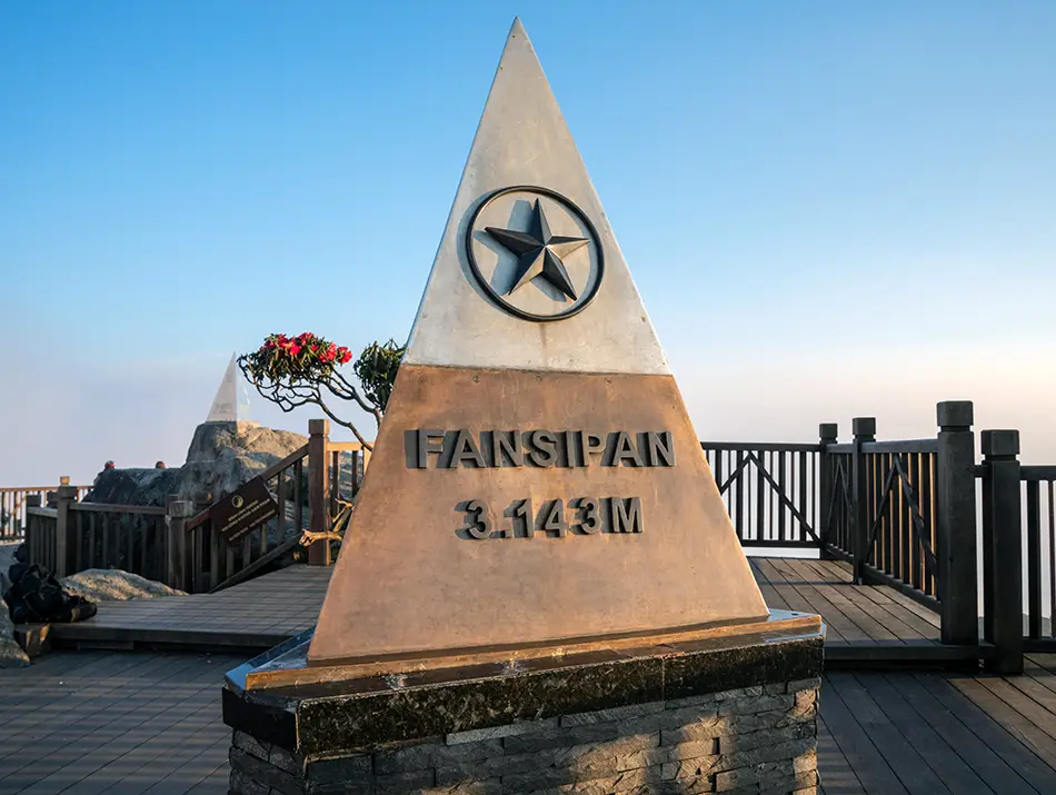 The Fansipan summit marker stands beneath a clear sky, highlighting one of the best things to do in Sapa.