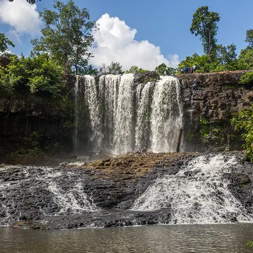 Water cascading over rocks in a jungle waterfall, a hidden gem in Mondulkiri.
