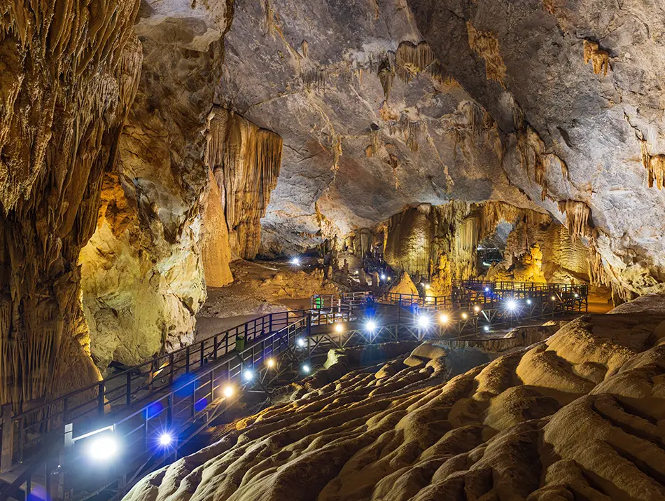 A grand chamber of Paradise Cave shows towering limestone formations under soft lighting.