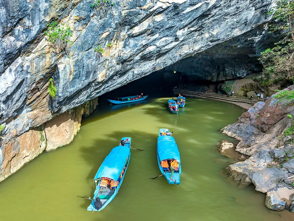 Boats enter Phong Nha Cave, one of the classic Things to see in Phong Nha.
