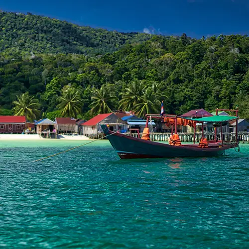 Colorful boats floating near the coast, one of the must-visit places in Cambodia.