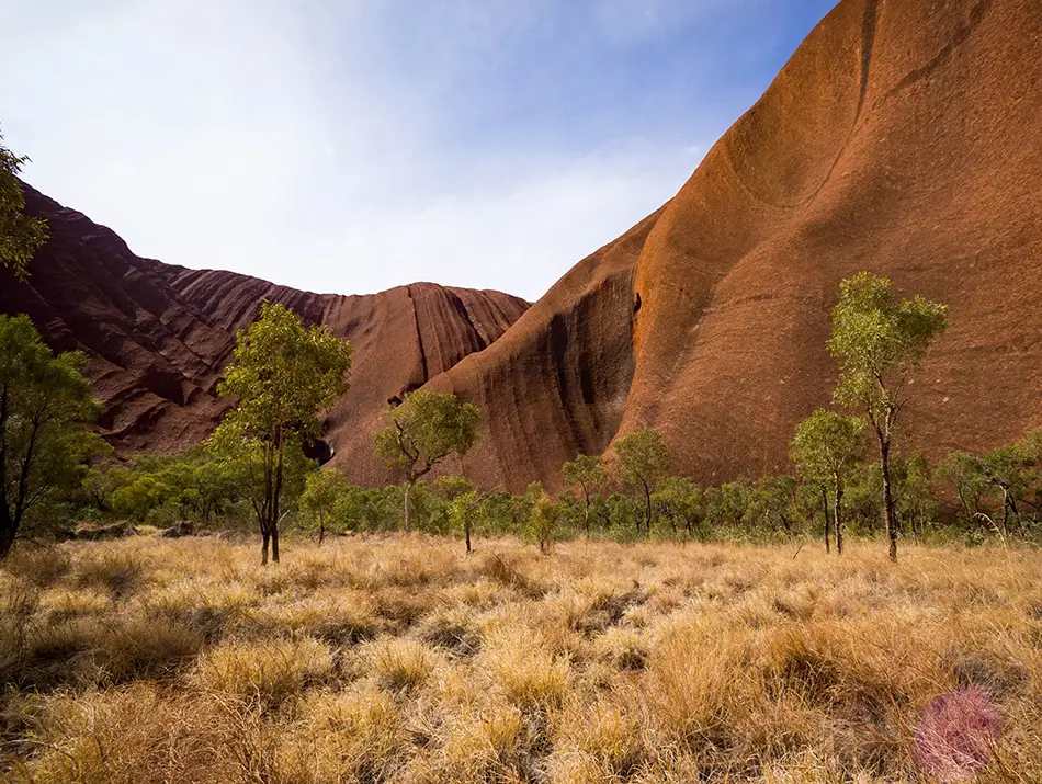 Red rock domes of Uluru-Kata Tjuta National Park, Australia, admired for sacred eco-tourism.