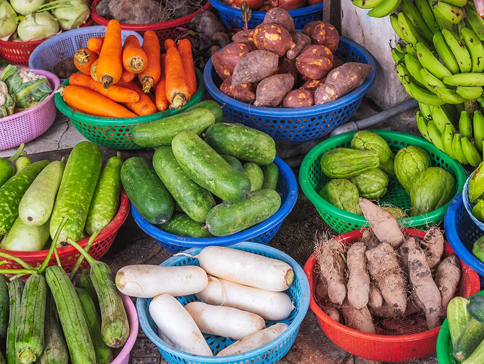Assorted vegetables and roots displayed at a local market stall.