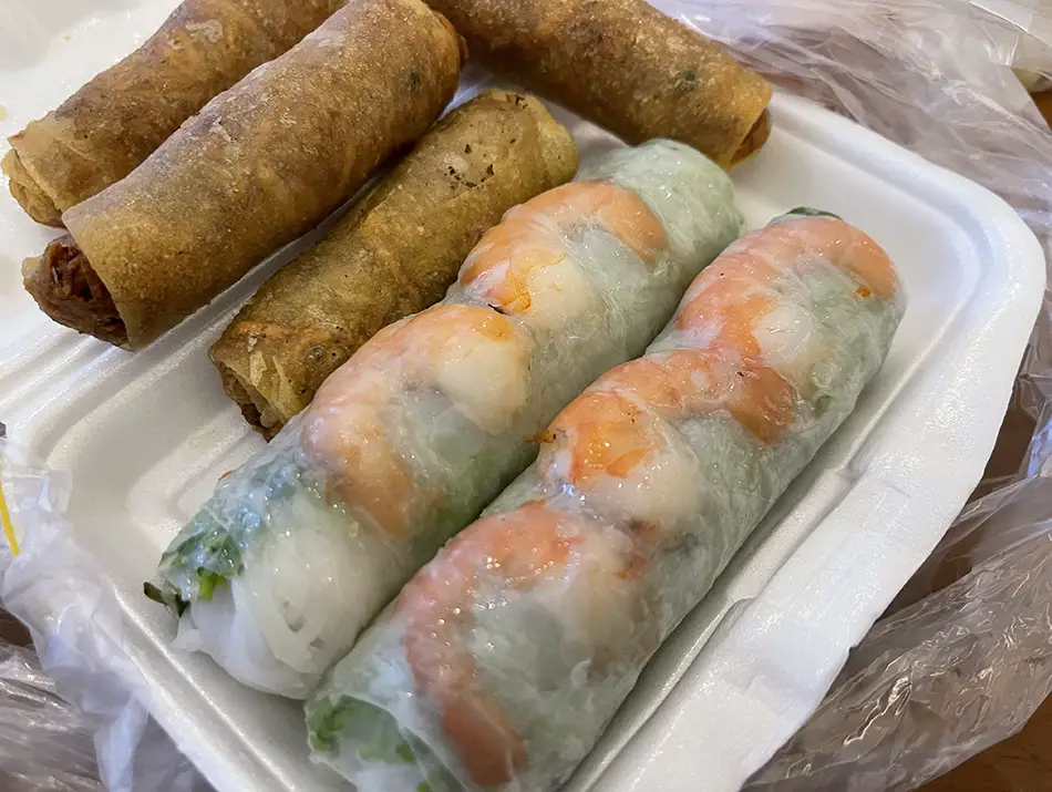 Fresh shrimp spring rolls and fried rolls commonly enjoyed as Vietnamese street food.