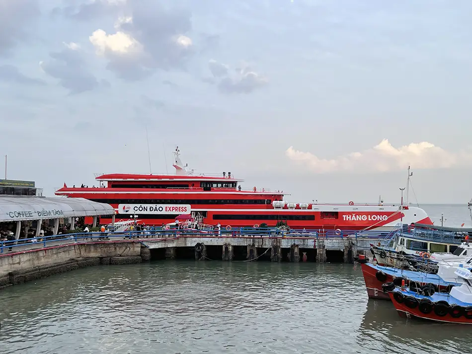 Vung Tau - Con Dao ferry docked at the harbor with passenger boats lined along the pier.