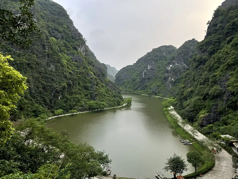 Hidden lake enclosed by limestone cliffs explaining why visit Ninh Binh.