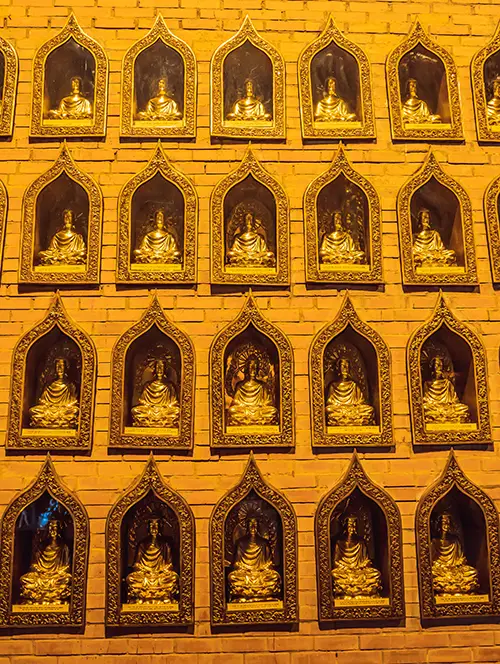 Rows of golden arhat statues inside one of the major attractions in Ninh Binh.
