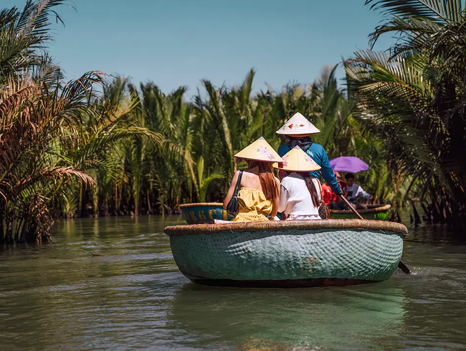 A round bamboo boat ride is a popular must-do in Hoi An through palm-lined waterways.