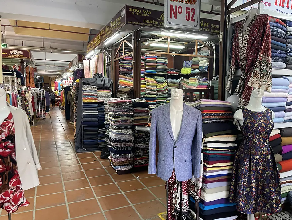 Fabric-lined shops illustrate attractions in Hoi An linked to custom tailoring traditions.