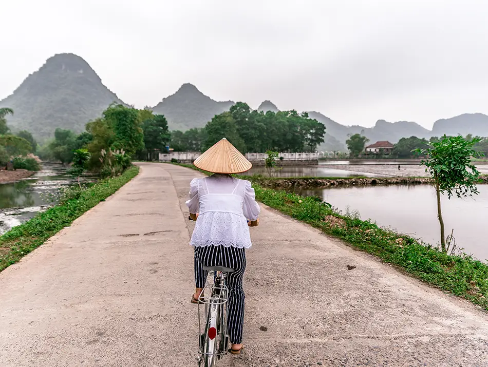 Cycling rural roads through fields, one of the popular activities in Ninh Binh.
