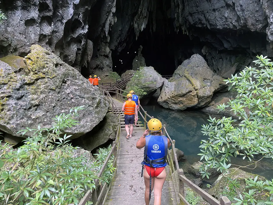 Adventure trail inside a narrow jungle cave showcasing one of the best caves in Vietnam.