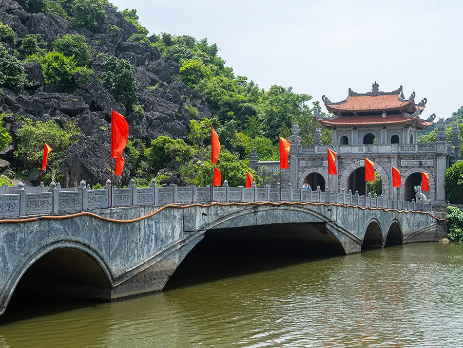 Historic stone bridge near temples, a cultural attraction in Ninh Binh.