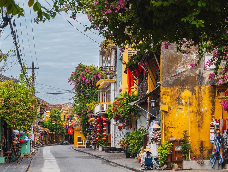 Colorful Hoi An street with yellow houses and bicycles.