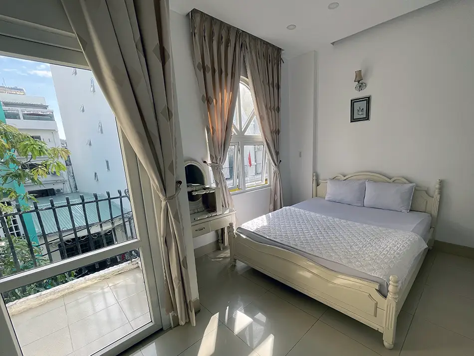 Cozy hotel room with neatly made bed and warm lighting near the coast.
