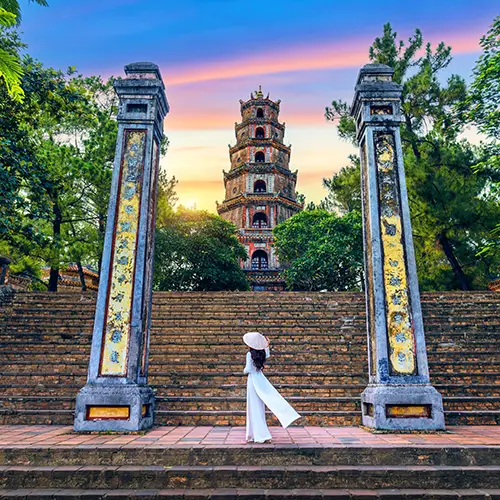 The steps leading to Thien Mu Pagoda framed by tall stone pillars and greenery.