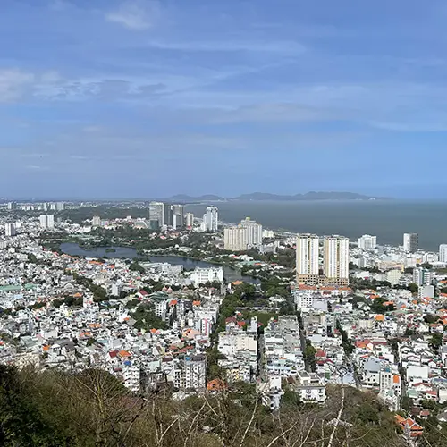 Sweeping city view from the historic lighthouse overlooking rooftops and the sea.