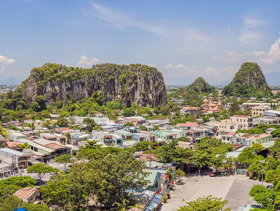 Limestone peaks and surrounding villages form a dramatic landscape near the coast.