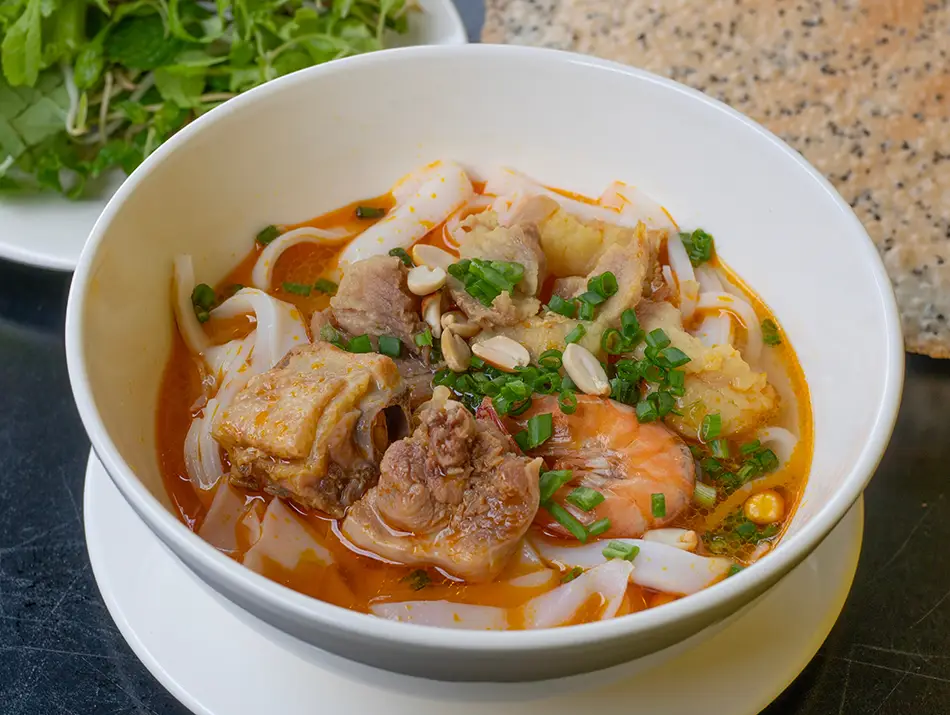 Traditional bowl of Mi Quang noodles showing local food in Da Nang.