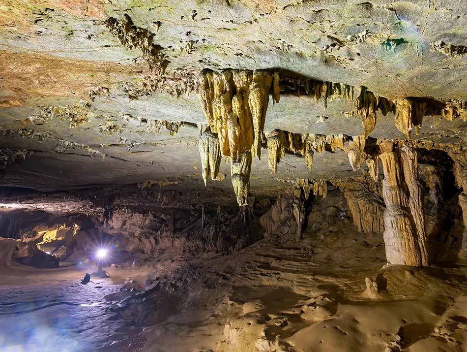 Large illuminated chamber filled with stalactites, among the most famous caves in Vietnam.