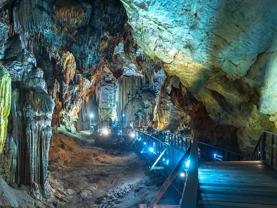 Wooden walkways crossing vast chambers, showcasing caves in Vietnam you can visit without a guide.