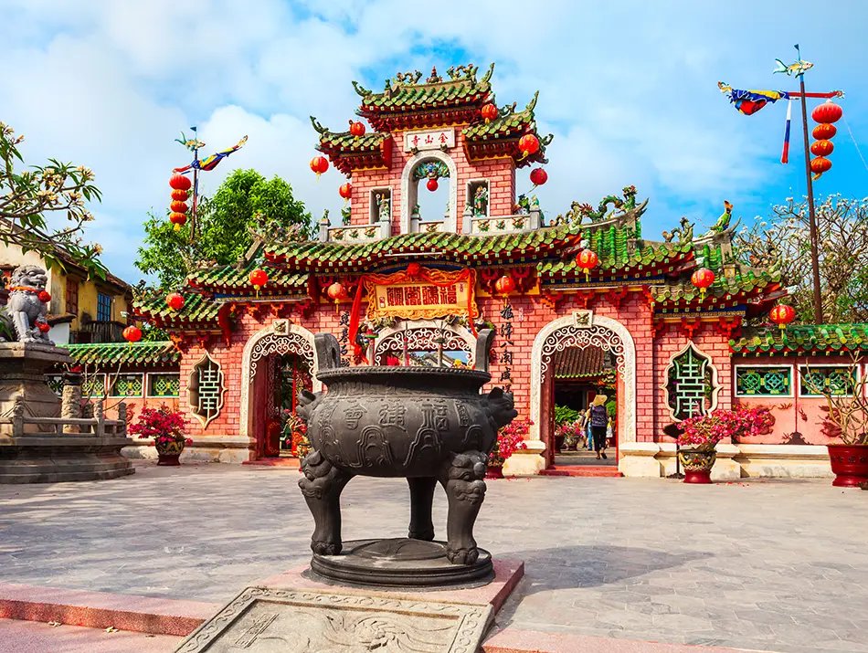 A richly decorated temple entrance highlights sights and activities in Hoi An centered on spiritual heritage.