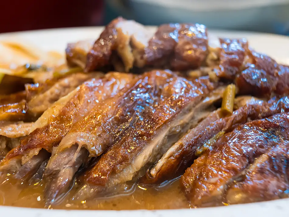 Seven-flavor roasted duck on a plate, one of the famous local dishes in the area.